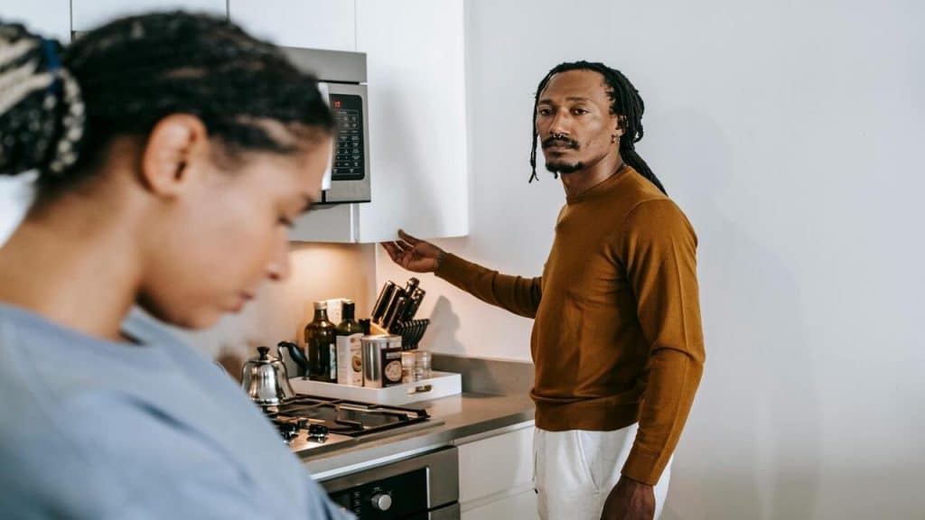 A couple looking somber in the kitchen
