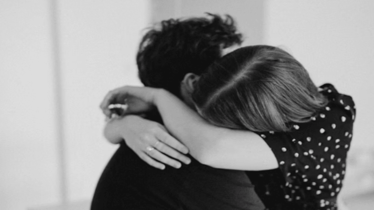 A couple hugging at home