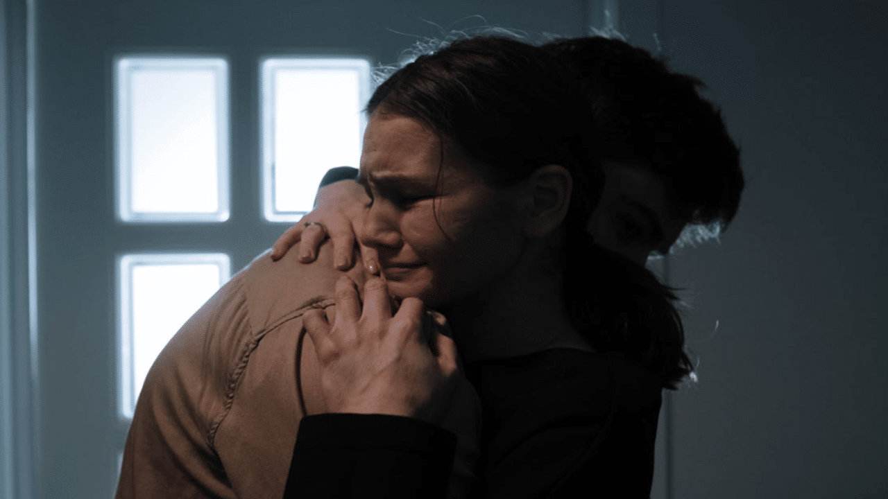 A man comforting his crying wife