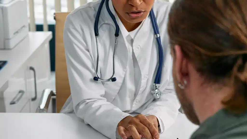 A doctor speaking with a patient during a medical appointment.