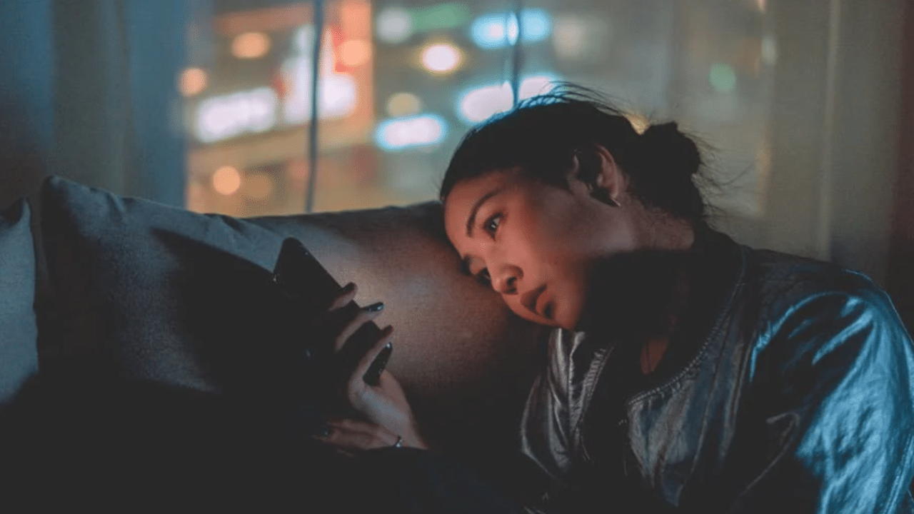 A woman looking sad while texting