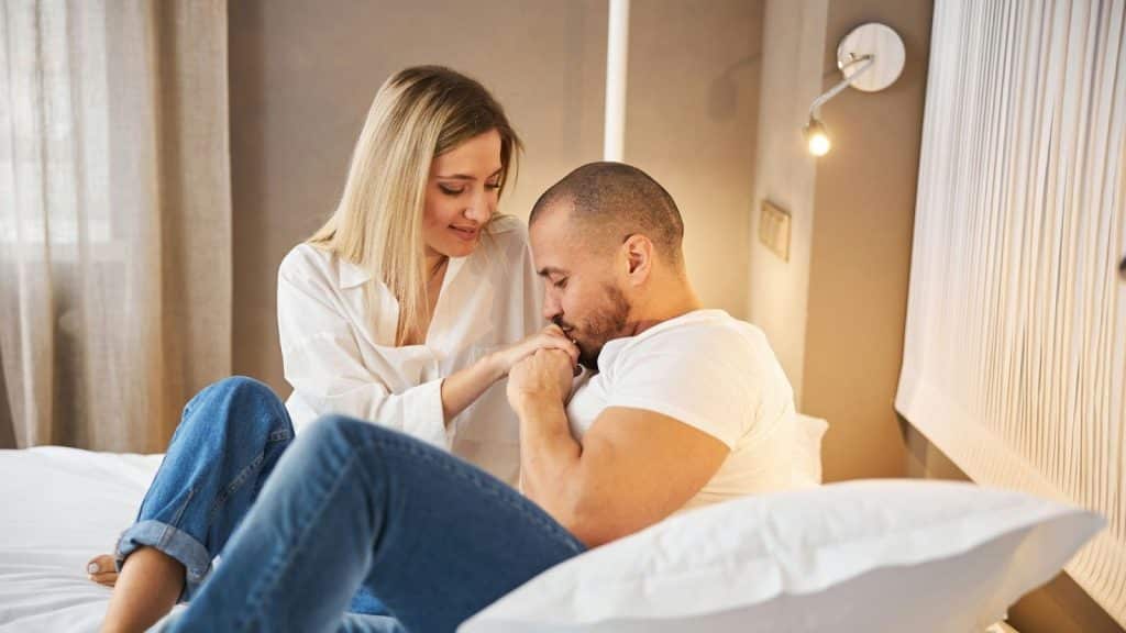 A man kissing a woman’s hand