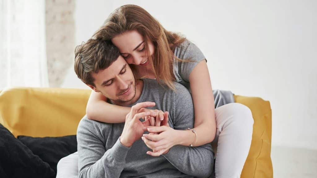 A woman hugging a man