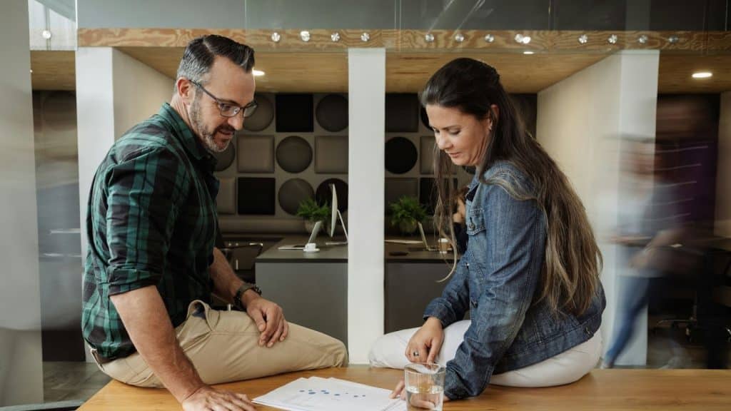 A man and a woman are having a conversation about work