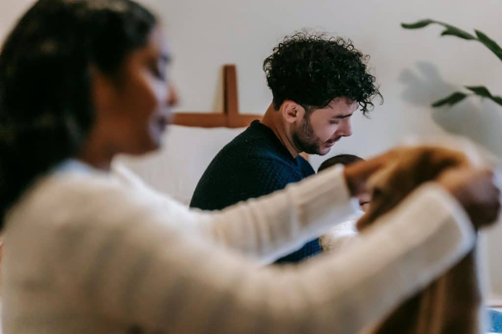 A man and woman being silent while doing house chores