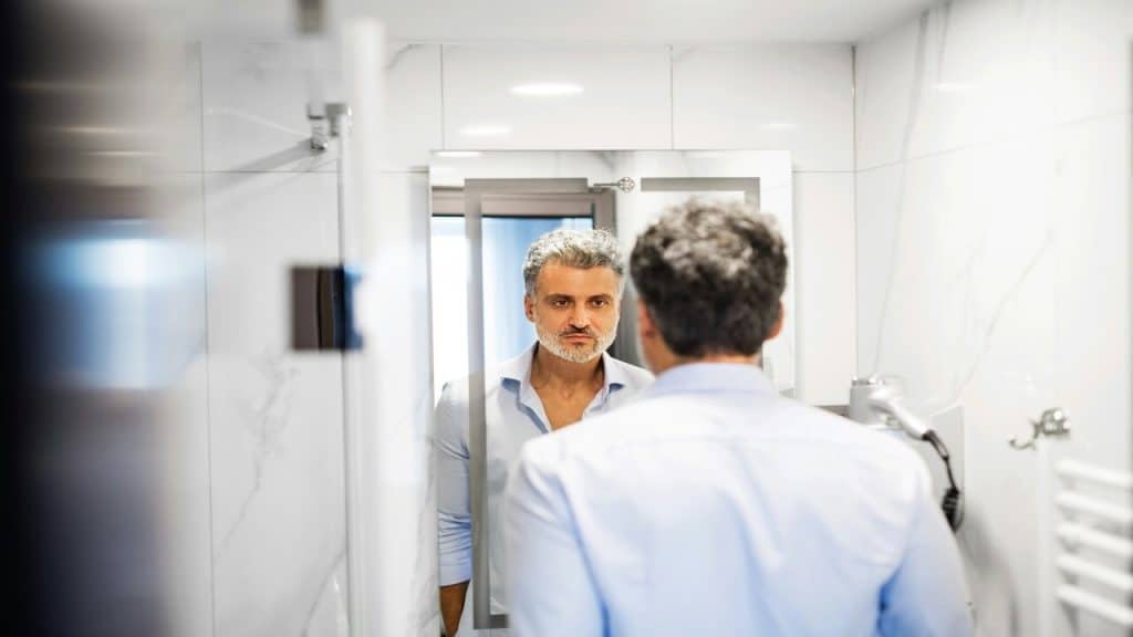A man looking at the mirror