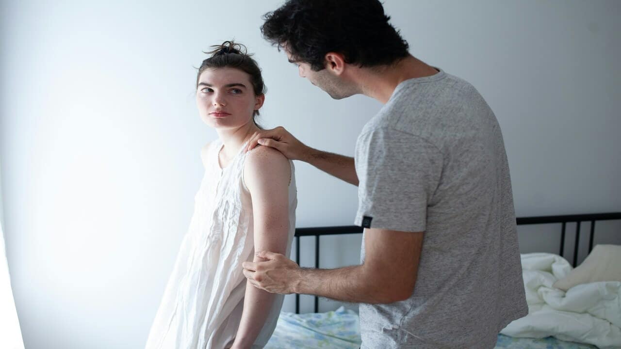 A man reassuring his girlfriend
