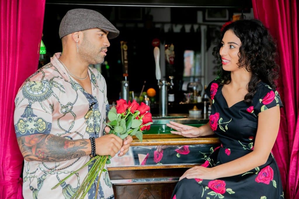 A man giving flower to woman 