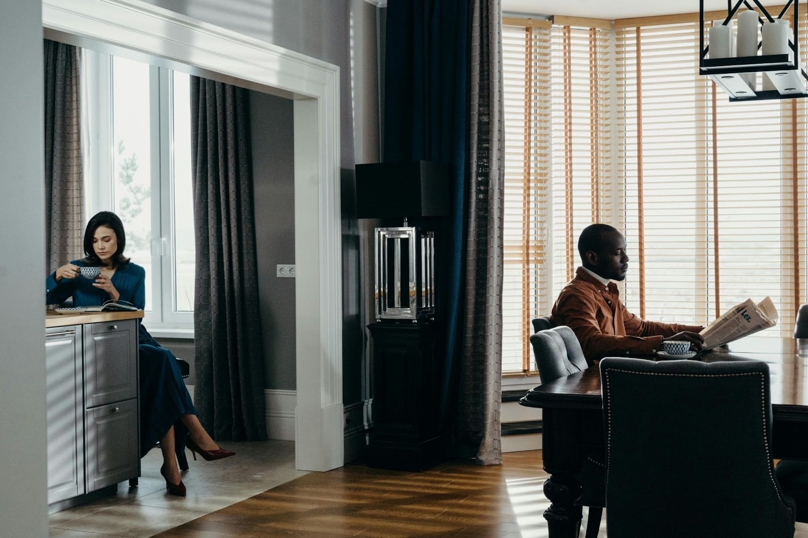 A man and woman at the same room but with different priorities