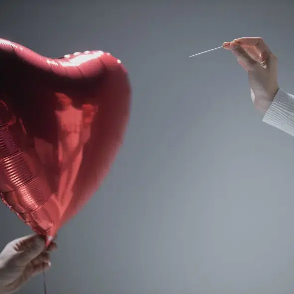 Person Holding Red Heart Balloon