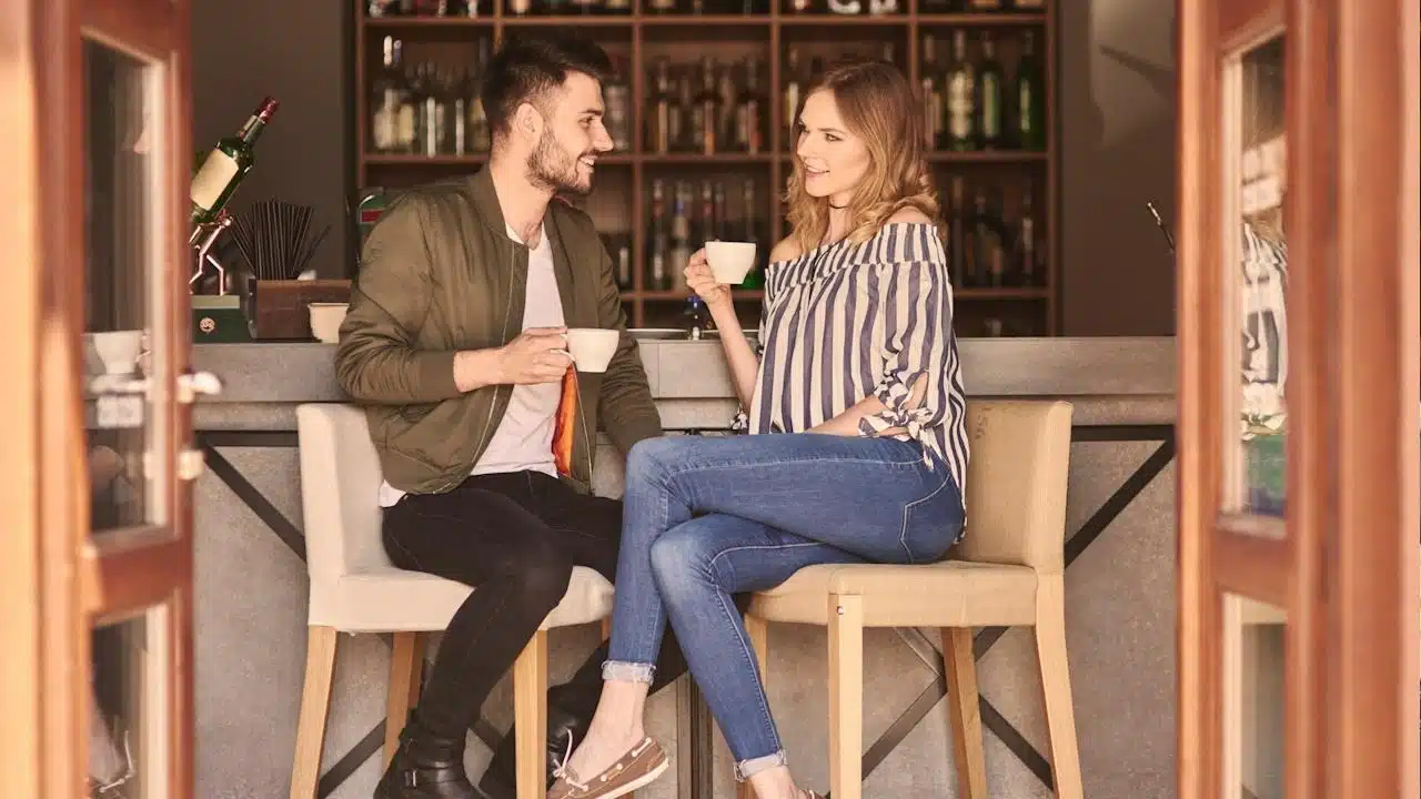 Man and woman talking and having coffee at a cafe.