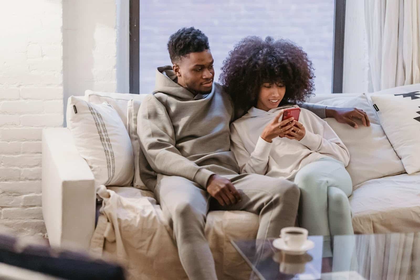 A woman using a phone and a man beside her