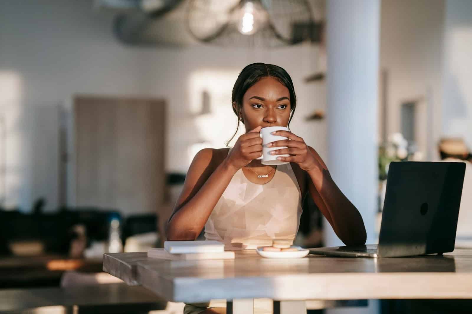 Woman thinking while drinking coffee