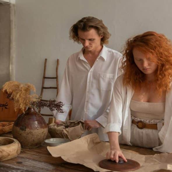 A couple wrapping ceramic bowls