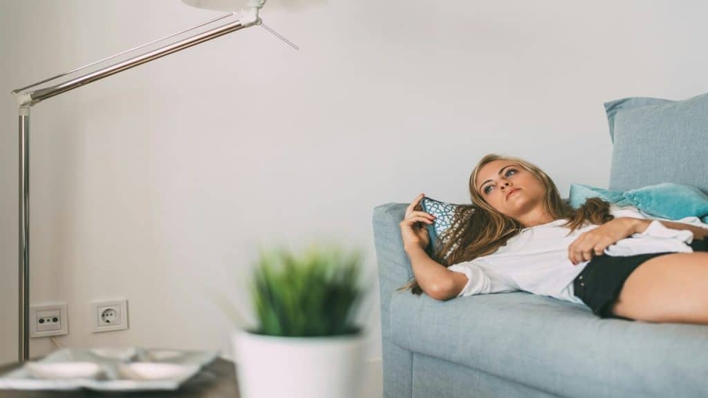 A woman looking sad at home