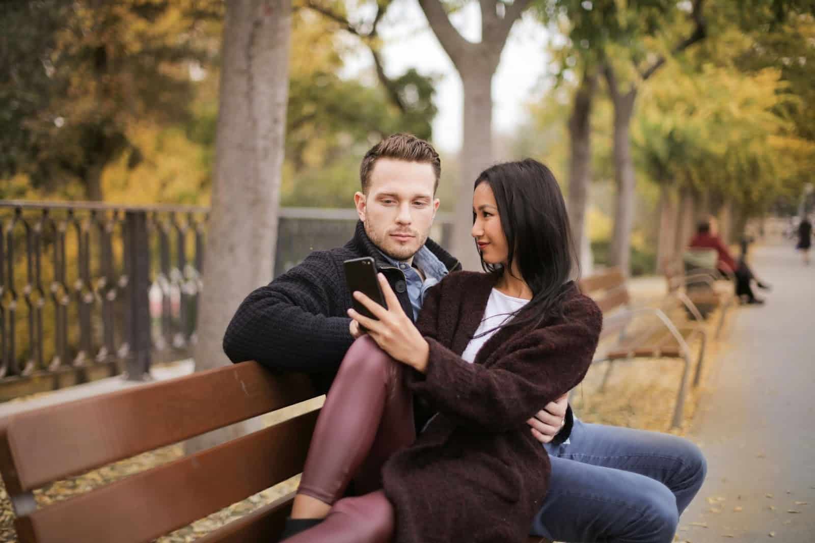 A man and woman at the wooden bench