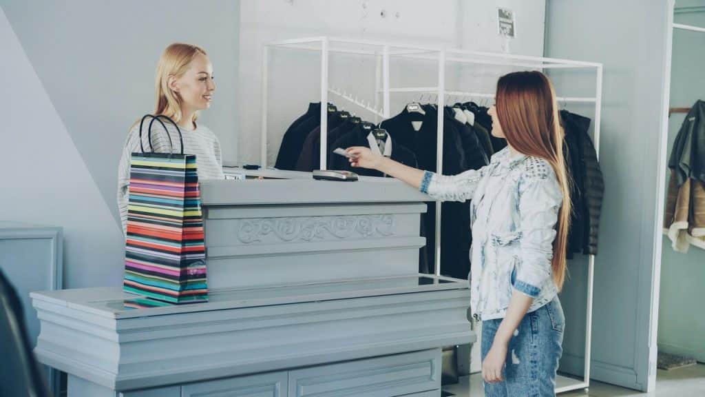 A woman handing her credit card
