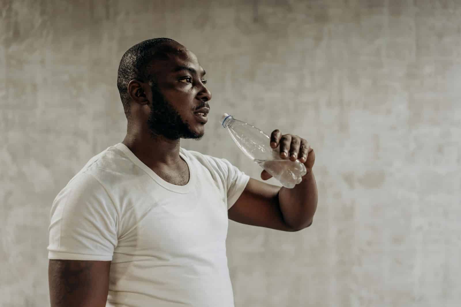 A man drinking water from a bottle