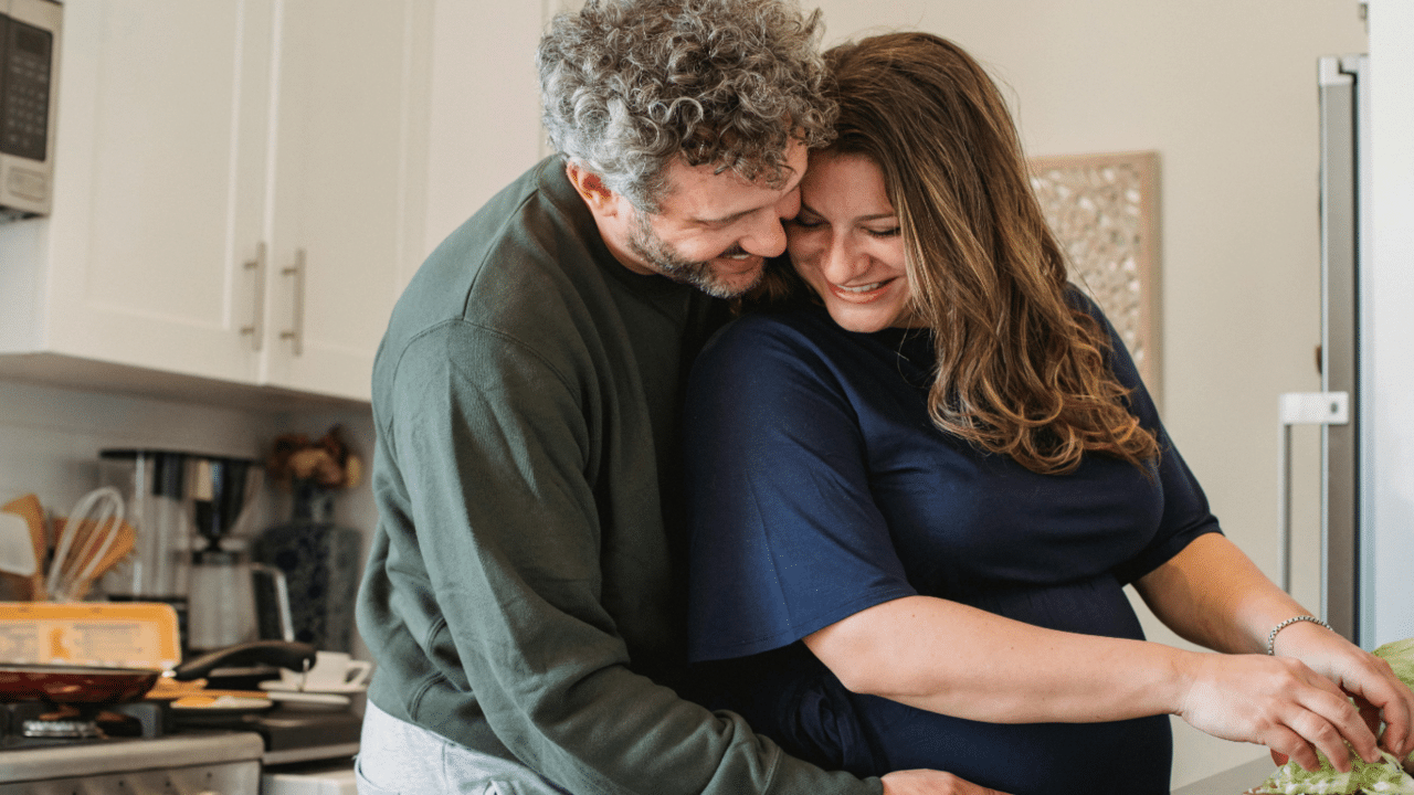 A couple hugging in the kitchen