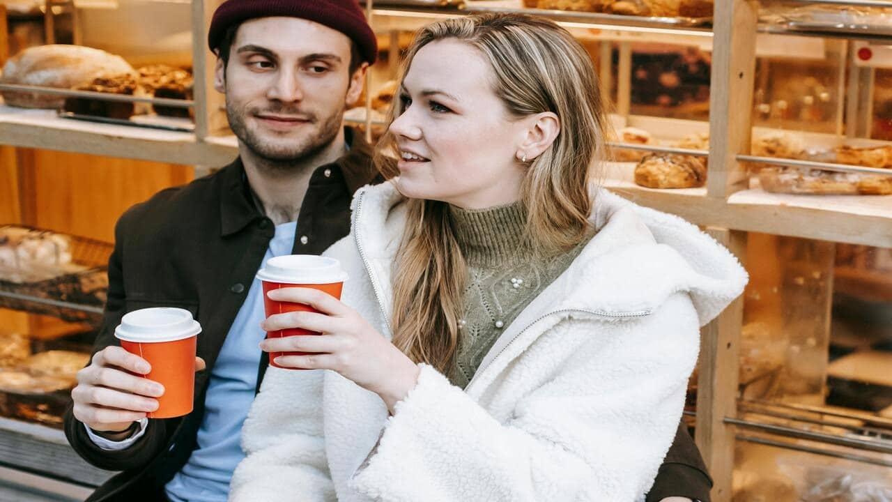 A couple talking while drinking coffee