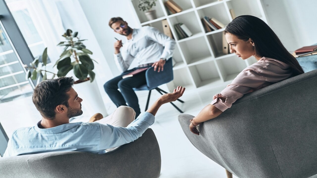 A man apologizing in front of a therapist
