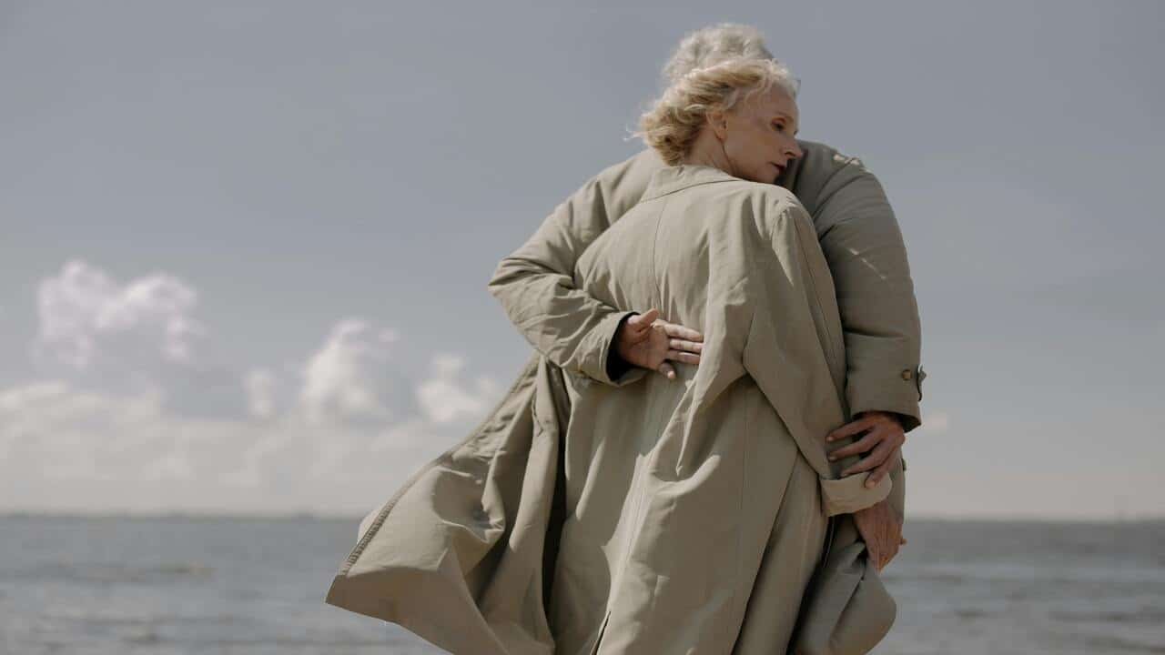An older couple hugging each other