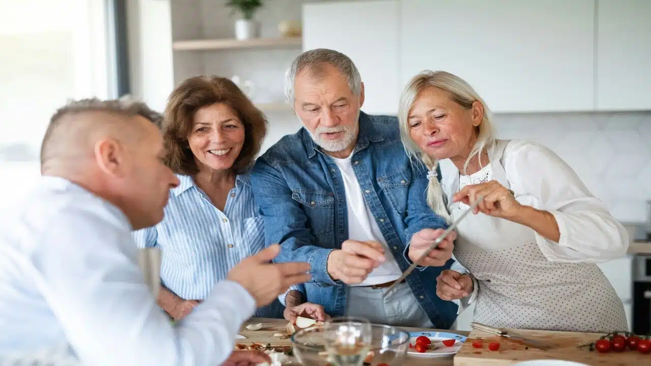 Older friends preparing a meal together
