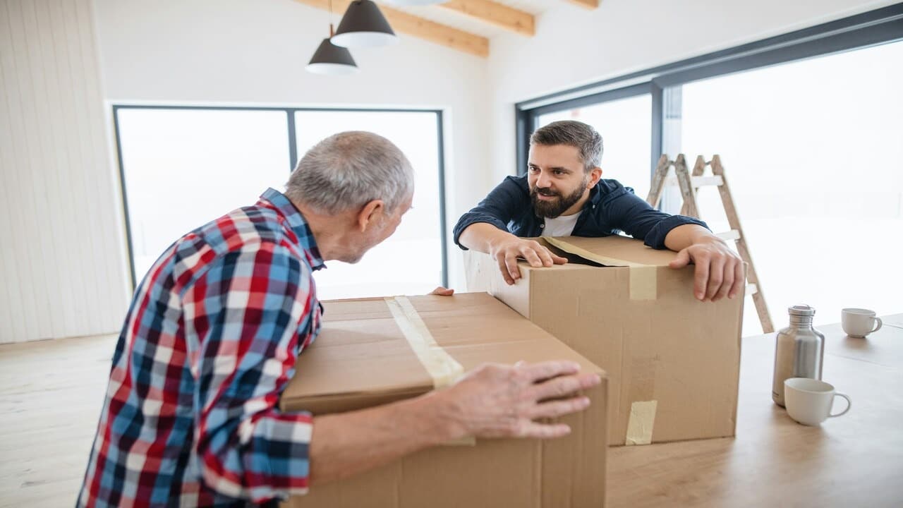 A man helping his father move