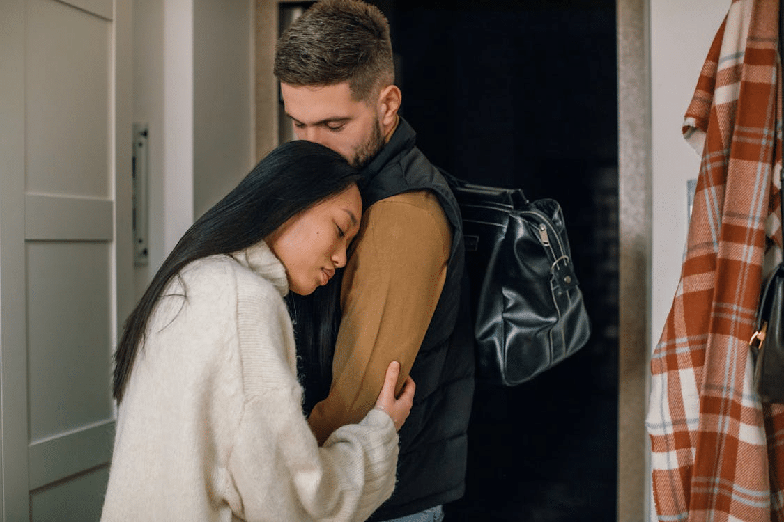 A man kissing a woman’s head