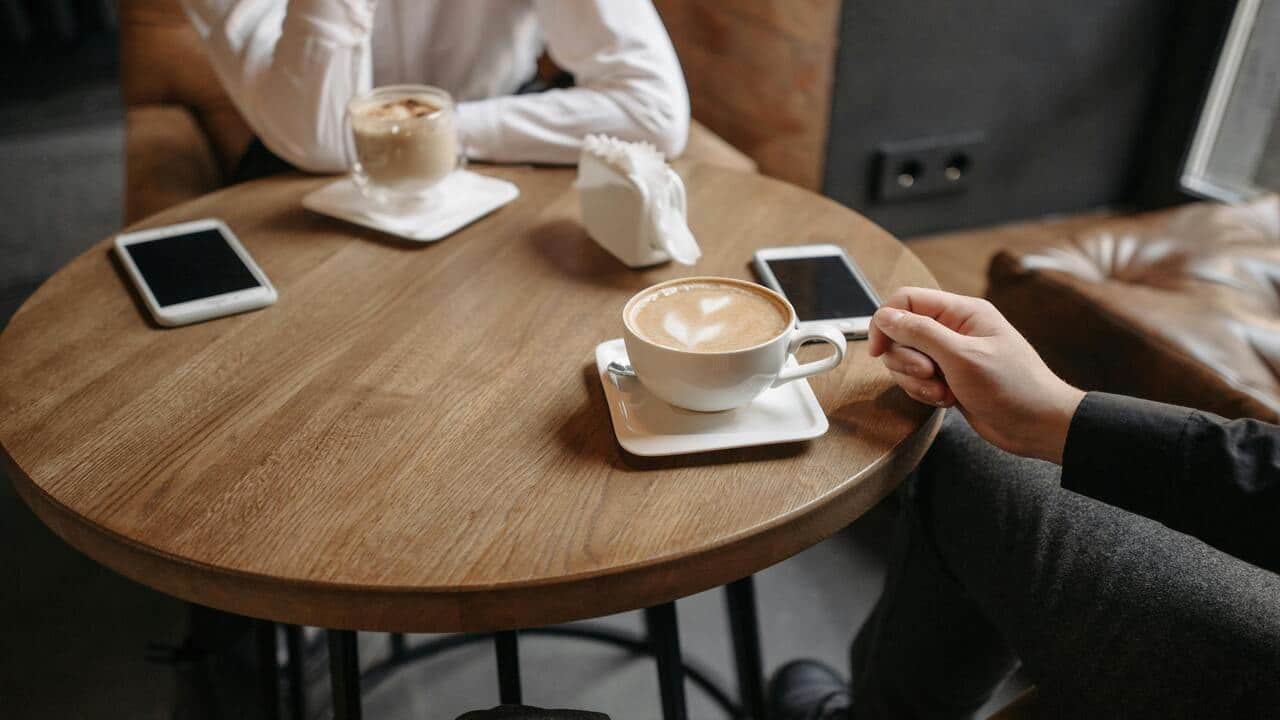 A couple talking over coffee