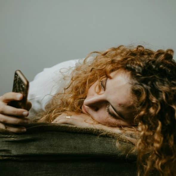 A woman waiting for a text
