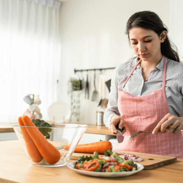 A woman looking serious while cooking