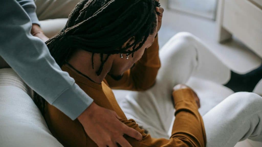 A person sitting with their head down