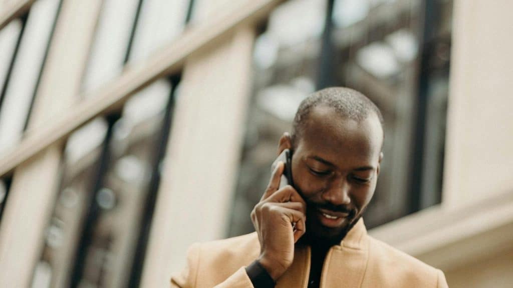 A man standing outside a building talking on his phone