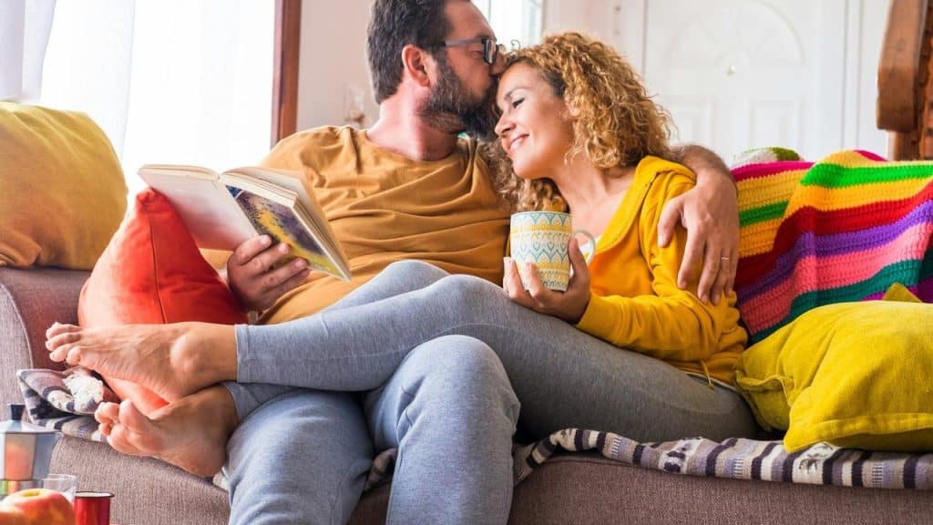 A couple cuddling on a couch