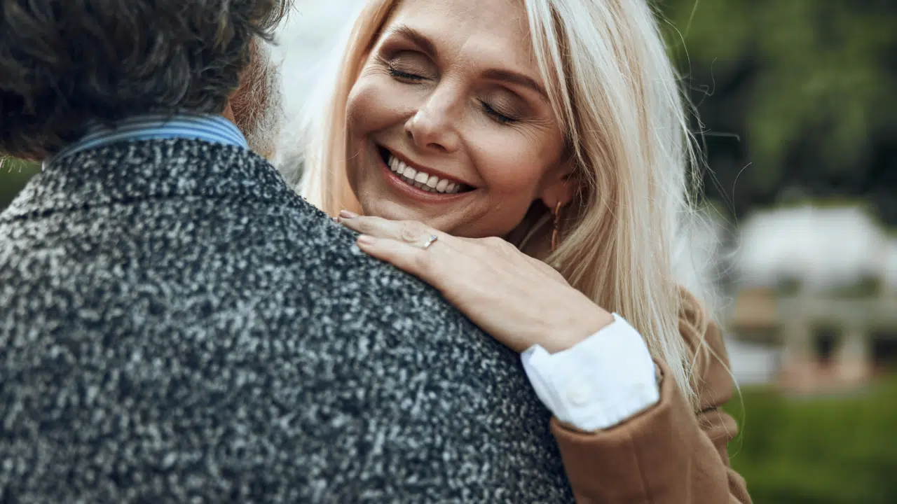A woman hugging her husband