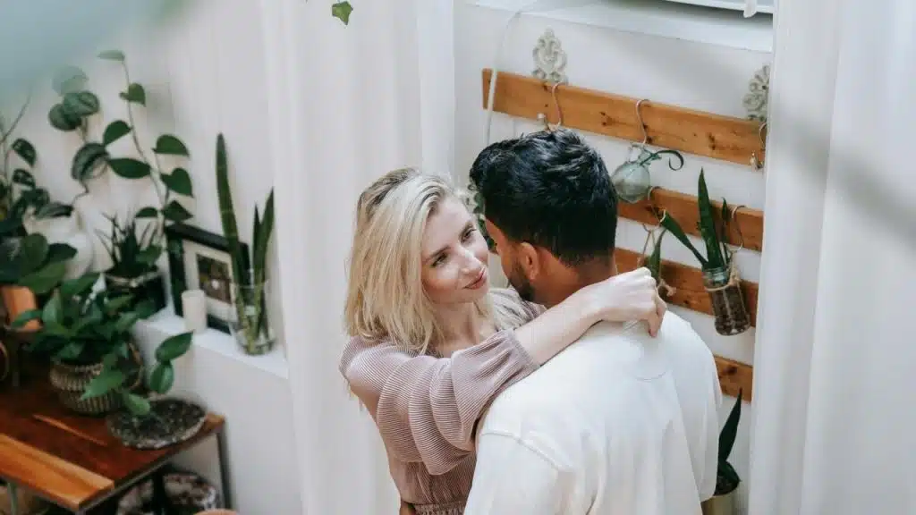 A couple embraces indoors