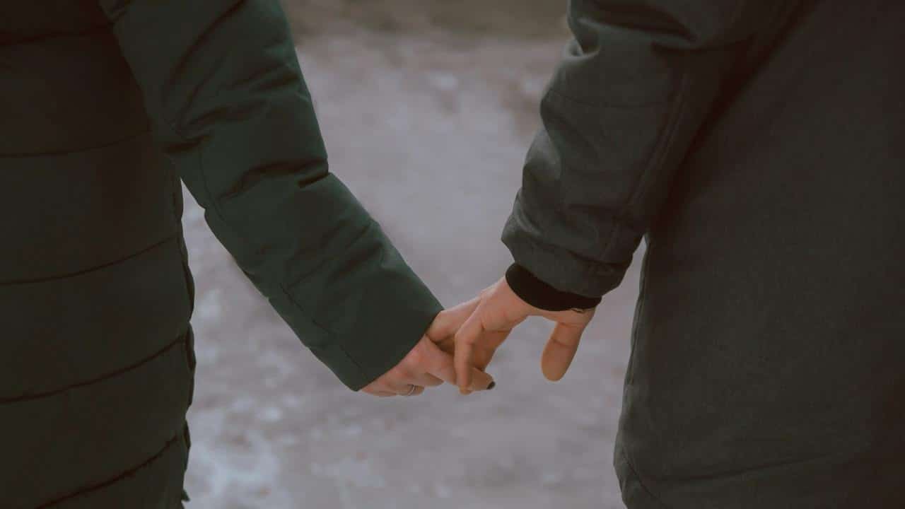 A couple holding hands.