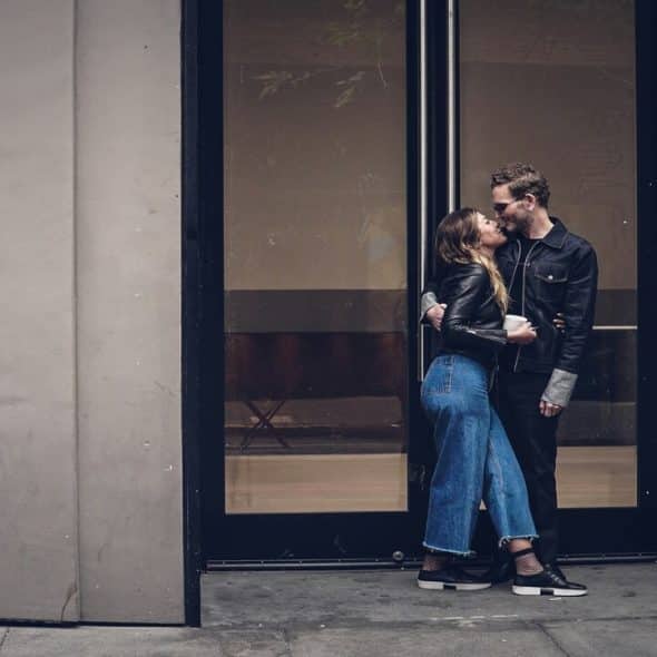 A couple kissing outdoors