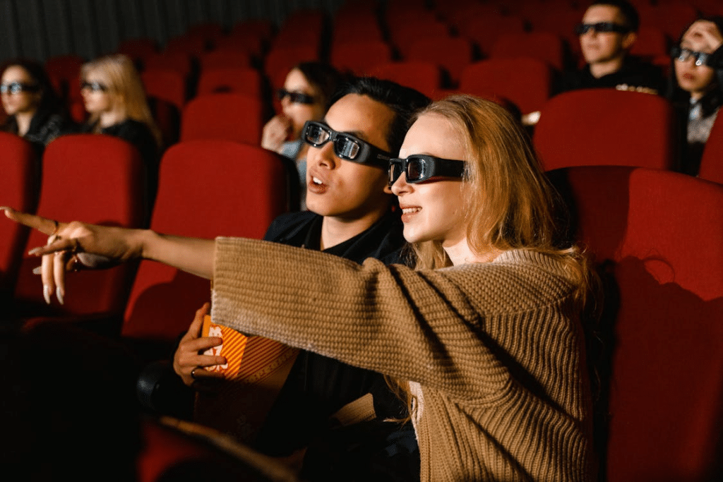 A Couple Wearing 3D Glasses while Watching a Movie