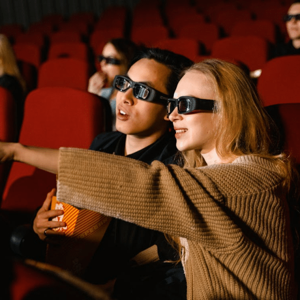 A Couple Wearing 3D Glasses while Watching a Movie