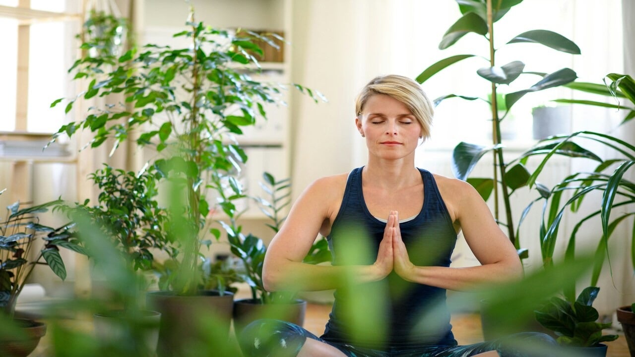 A woman doing yoga at home