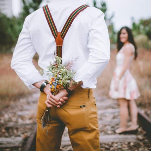 man with flowers outdoors