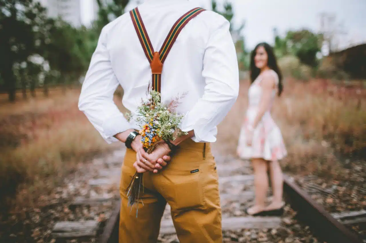 man with flowers outdoors