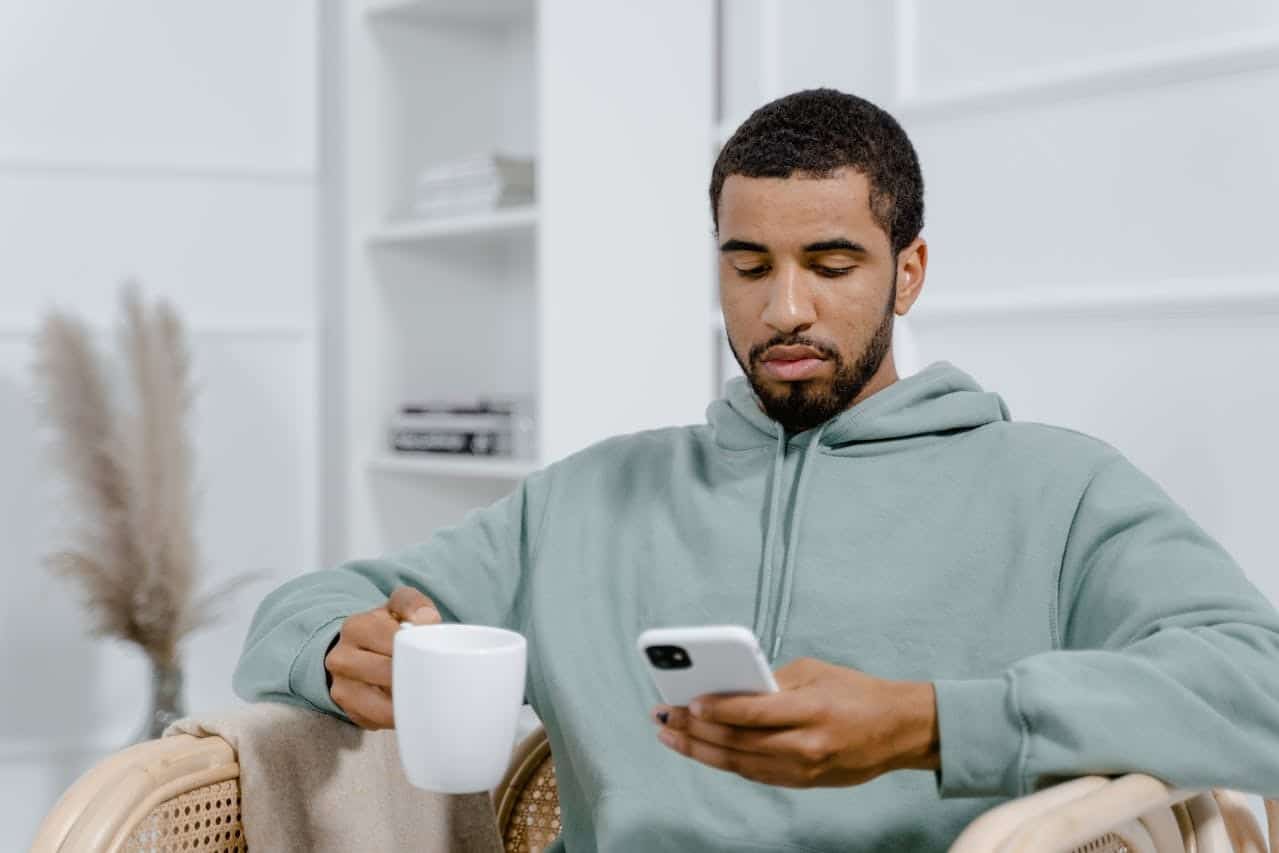 man scrolling phone