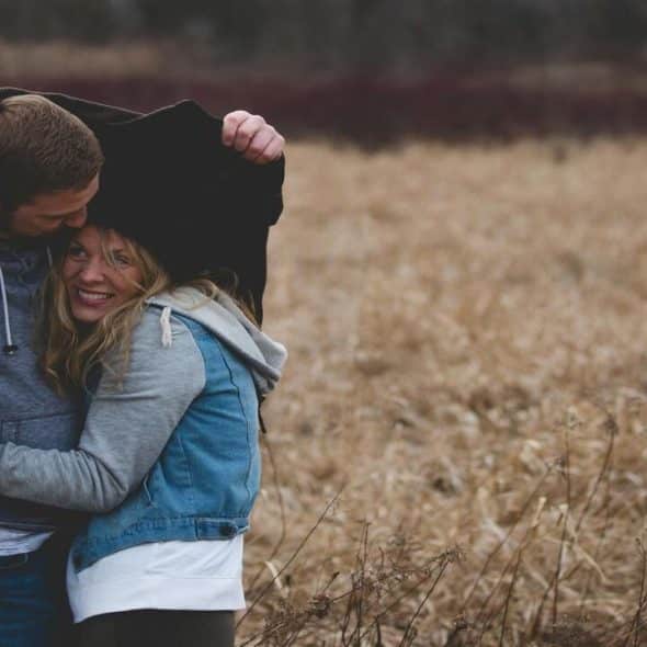 A couple sharing a jacket