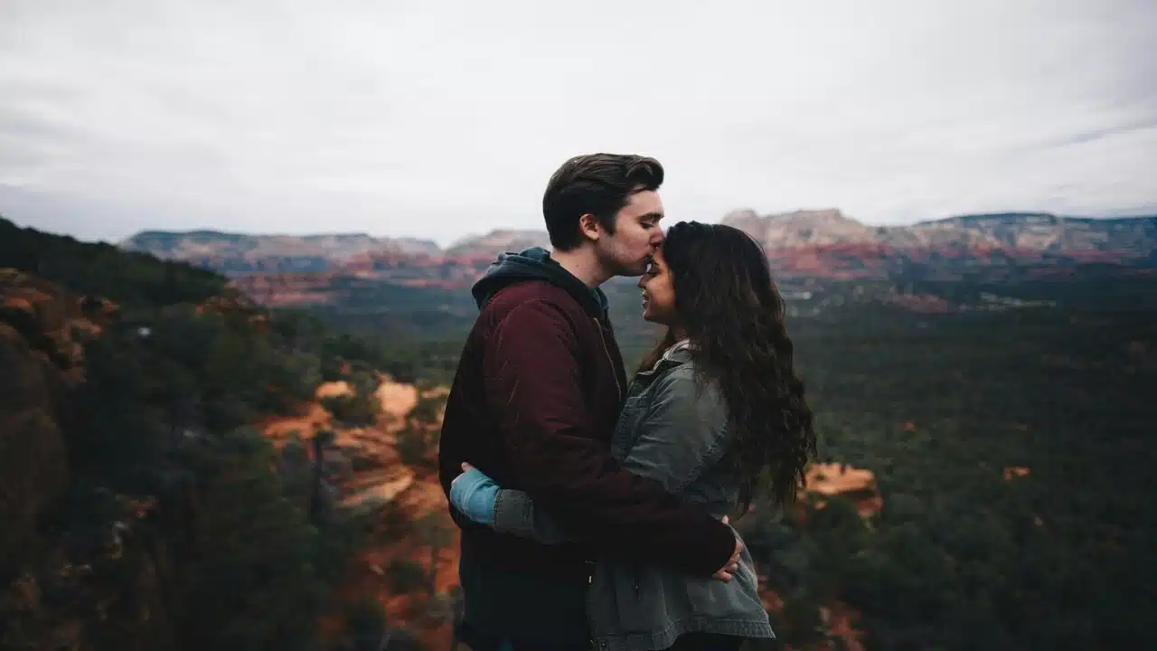 A man kissing a woman’s forehead