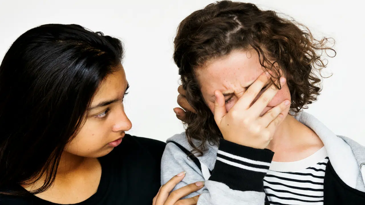A woman comforting her friend