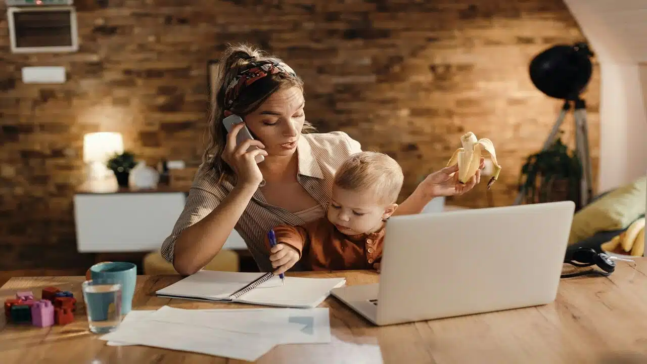 A mom working while taking care of her baby