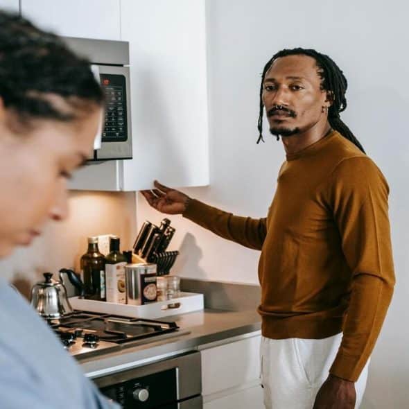 A couple looking somber in the kitchen